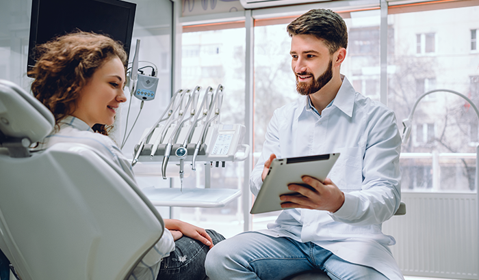 patient and dental professional speaking in a dental office setting