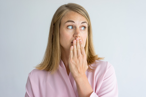 Woman holding her hand in front of her mouth in Chicago