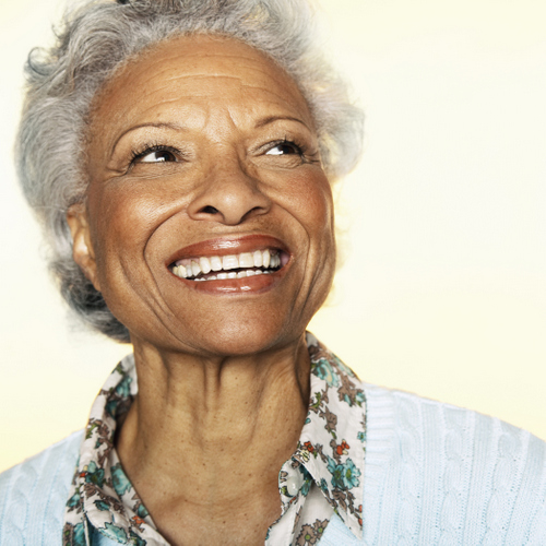 Older Chicago woman smiling after getting her teeth replaced at East Village Dental Centre in Chicago.